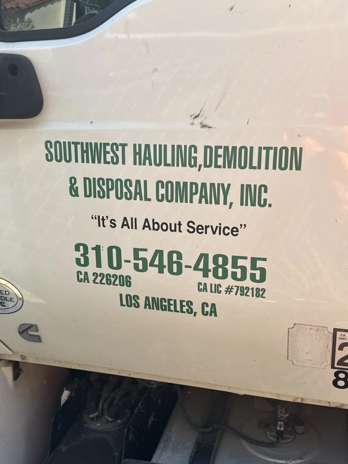 Southwest Hauling Demolition and Disposal truck door with the company phone number and CA license